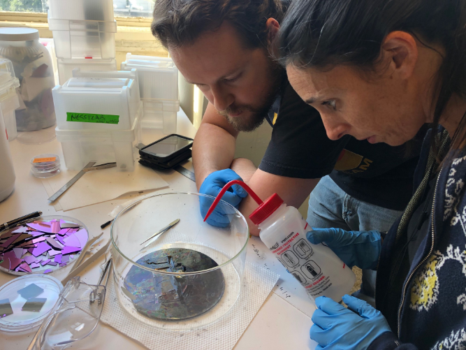 Luiz Acauan and Estelle Kalfon-Cohen inspect the diamond during removal from a processing substrate in MIT necstlab, just prior to CNT growth.